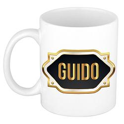 Foto van Naam cadeau mok / beker guido met gouden embleem 300 ml - naam mokken