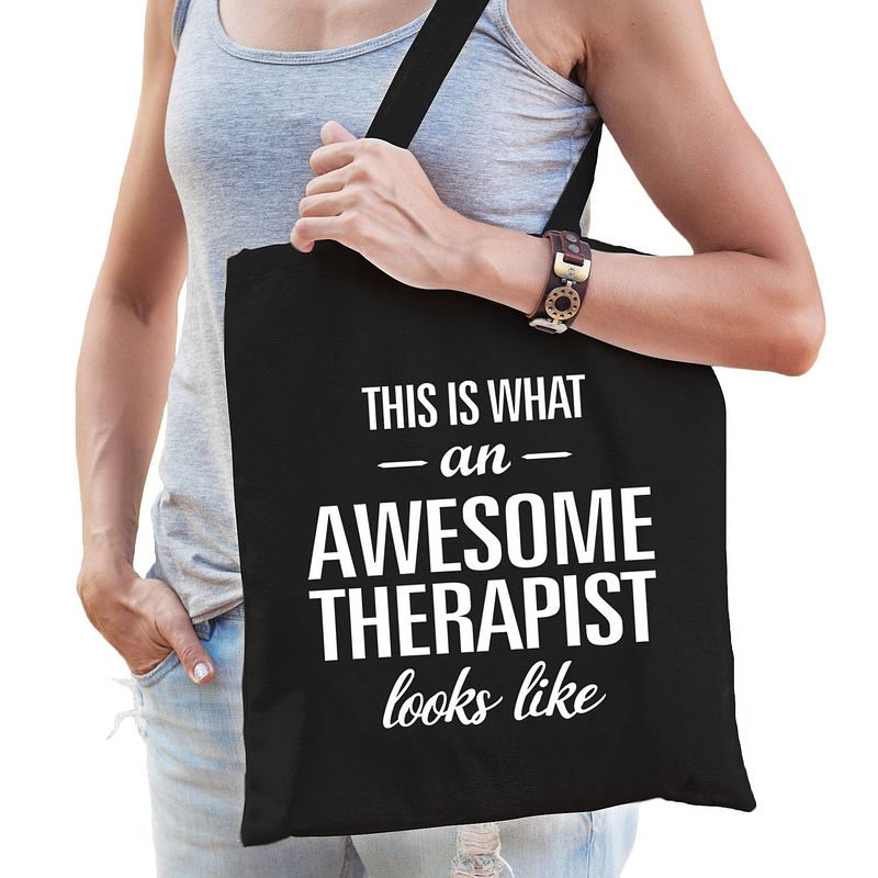 Foto van Awesome therapist / geweldige therapeut cadeau tas zwart voor dames en heren - feest boodschappentassen