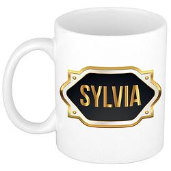 Foto van Naam cadeau mok / beker sylvia met gouden embleem 300 ml - naam mokken