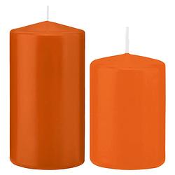 Foto van Stompkaarsen set van 4x stuks oranje 12 en 15 cm - stompkaarsen