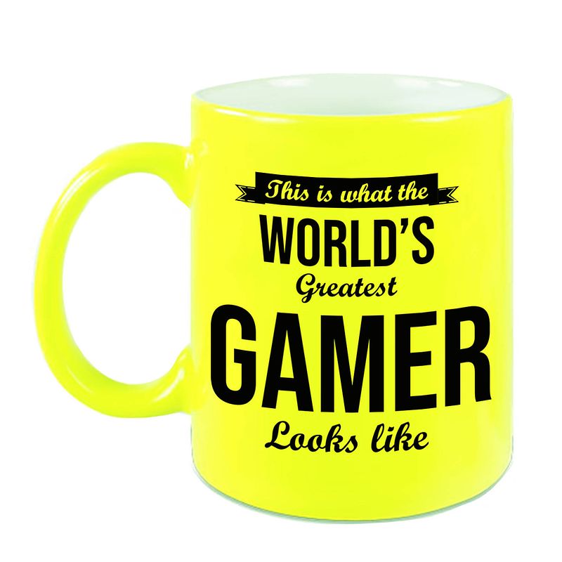 Foto van Worlds greatest gamer cadeau koffiemok / theebeker neon geel 330 ml - feest mokken