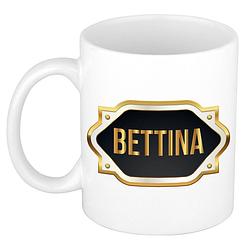 Foto van Naam cadeau mok / beker bettina met gouden embleem 300 ml - naam mokken