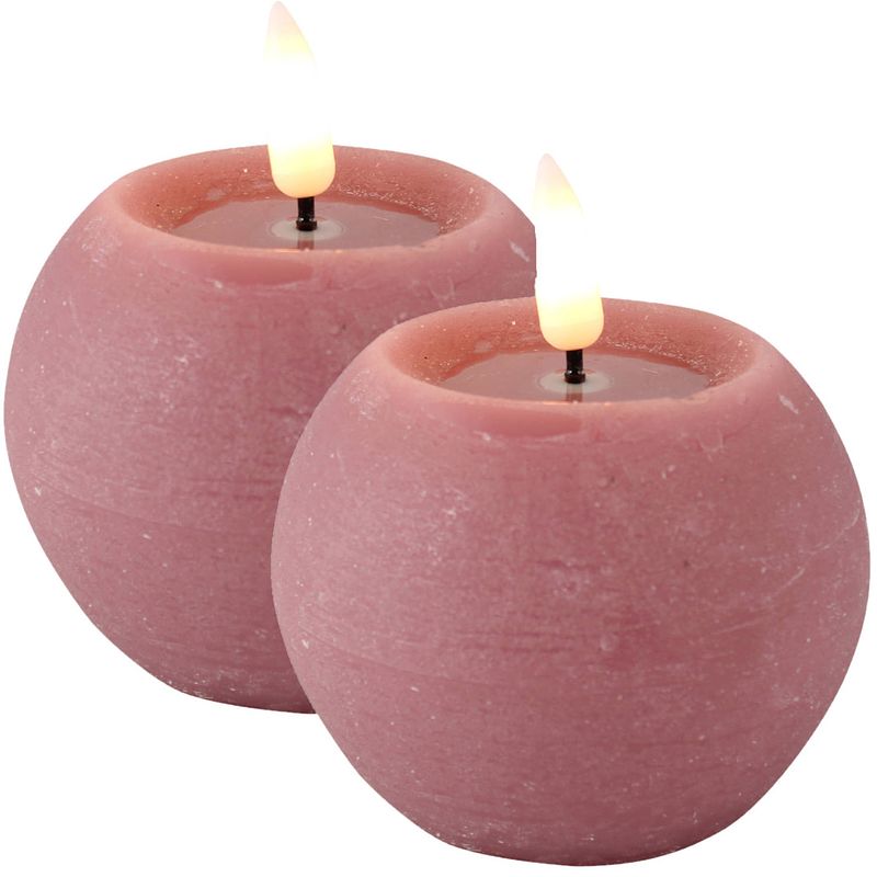 Foto van Magic flame led kaarsen/bolkaarsen - 2x st- rond - roze - d8 x h7,5 cm - led kaarsen
