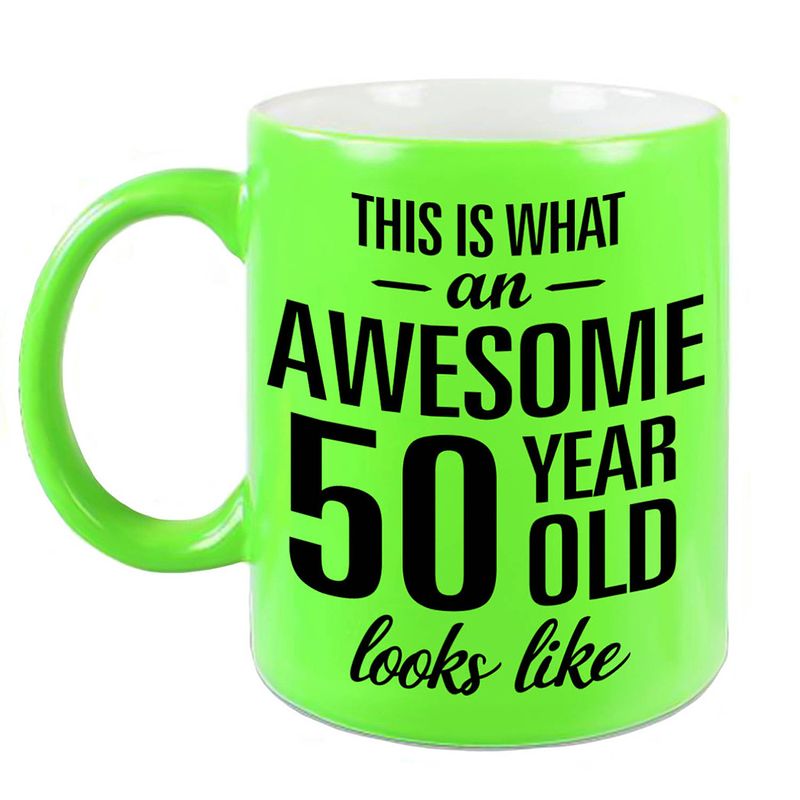 Foto van Awesome 50 year cadeau mok / beker neon groen 330 ml - feest mokken